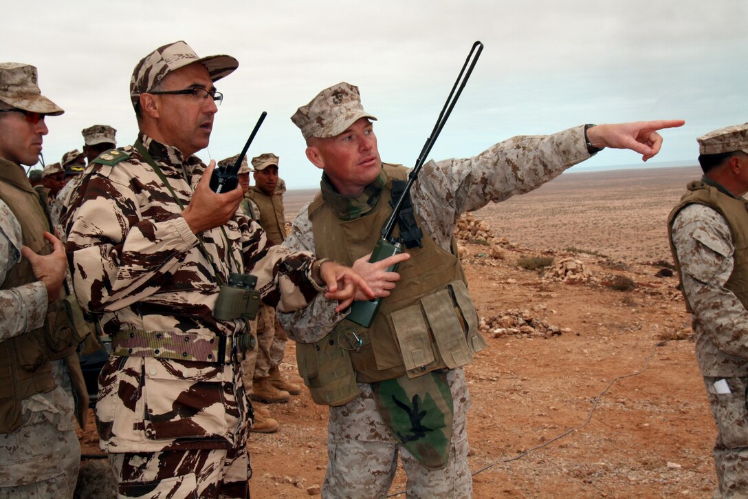 Marine Corps Reserve Maj. Benjamin Wagner (right) the commanding officer of Weapons Company, 2nd Battalion, 24th Marine Regiment, and Col. Abdelmajid Chazi of the Royal Moroccan Army coordinate with vehicle maneuver elements of both countries' forces during the culminating live-fire exercise of African Lion 2010, a theater security cooperation exercise conducted annually between U.S. and Moroccan forces.